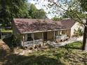 Charming single-story home with a covered front porch, landscaped yard, and inviting curb appeal at 11312 Haskell Dr, Clermont, FL 34711