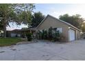 This property offers a long driveway leading to an oversized garage, complemented by landscaping and ample parking space at 11312 Haskell Dr, Clermont, FL 34711