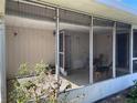 Enclosed porch with screen windows, plants, and a dog at 15159 Sw 43Rd Terrace Rd, Ocala, FL 34473