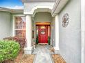 Inviting front entrance featuring a decorative door and manicured landscaping at 1738 Sw 157Th Place Rd, Ocala, FL 34473