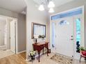 Bright foyer with tile flooring, decorative mirror and lamp table at 1738 Sw 157Th Place Rd, Ocala, FL 34473