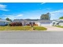 Charming single-story home with a well-manicured lawn, brick accents, and an attached two-car garage at 17594 Se 95Th Cir, Summerfield, FL 34491