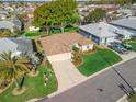 Aerial view of a single-story home with a manicured lawn and mature landscaping in a quiet neighborhood at 17898 Se 125Th Cir, Summerfield, FL 34491