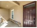 Inviting front porch with stone accents, a modern dark wooden front door and natural light at 1852 Rafton Rd, Apopka, FL 32703