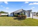 Well-kept home with landscaping and three car garage on a lush green lawn at 1853 Pasqua Pl, The Villages, FL 32163