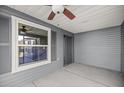Covered patio with ceiling fan and view to the outdoor screened lanai at 1853 Pasqua Pl, The Villages, FL 32163