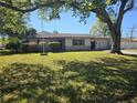 Lovely one-story home featuring a green lawn, beautiful shrubbery, and a two-car garage at 2181 Gretna Dr, Deltona, FL 32738