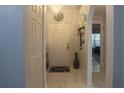 Bright entryway with a chandelier, decorative accents, and a welcoming 'Aloha' mat by the front door at 2442 Foxhollow Rd, Tavares, FL 32778