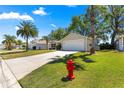 Charming single-story home with a two-car garage, lush landscaping, and a welcoming curb appeal at 2488 Ansley Path, The Villages, FL 32162