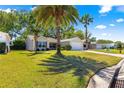 Well-maintained single-story home featuring a two-car garage and lush green lawn at 2488 Ansley Path, The Villages, FL 32162