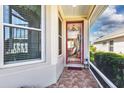 Tiled front porch offering a glimpse into the home's interior at 27121 Greenfly Orchid Ln, Leesburg, FL 34748