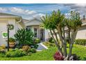 Beautifully landscaped walkway leading to the front entrance of the home at 27121 Greenfly Orchid Ln, Leesburg, FL 34748