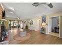 Bright living room with wood flooring, access to the lanai, and nautical decor at 28416 Tammi Dr, Tavares, FL 32778
