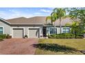 Charming home featuring a brick driveway, manicured lawn, and a welcoming entrance at 3512 Belland Cir # B, Clermont, FL 34711