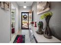 Inviting foyer with decorative vases, a console table, and a view of the front door at 3512 Belland Cir # B, Clermont, FL 34711