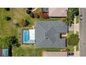 Aerial view of home with a screened-in pool, landscaped yard, and a well maintained roof at 3728 Mulberry Grove Loop, Leesburg, FL 34748