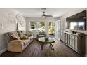 Inviting living room with modern flooring, comfortable seating, and bright light from windows at 3860 Branch Ave, Mount Dora, FL 32757