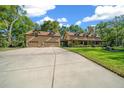 Lovely home featuring an oversized three-car garage, green lawn, and a covered porch with dormer windows at 39636 Carolina Ave, Lady Lake, FL 32159