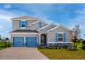 Charming two-story home featuring blue shutters, a two-car garage, and a well-maintained lawn at 5481 Marshelder St, Apopka, FL 32712