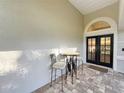 Arched front porch with brick flooring and seating area outside the front door at 5813 Lake Emma Ct, Groveland, FL 34736