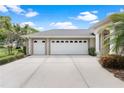 Spacious three-car garage with a wide driveway, ideal for vehicle storage and convenience at 6106 Spinnaker Loop, Lady Lake, FL 32159
