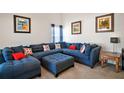 Spacious living room showcasing a large blue sectional and comfortable seating at 638 Sierra Cir, Davenport, FL 33837