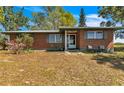 Charming single-story brick home with a cozy front porch and well-maintained landscaping at 6988 Blue Cedar Rd, Leesburg, FL 34748