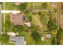 An aerial view of a home highlighting a well-maintained yard at 7636 Lake Angelina Dr, Mount Dora, FL 32757