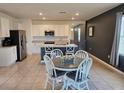 Open-concept kitchen and dining area with stainless steel appliances and seating for four at 808 Brooklet Dr, Davenport, FL 33837