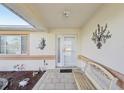 Inviting covered front porch features decorative wall art and a charming bench at 9857 Sw 63Rd Ct, Ocala, FL 34476