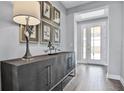 Bright entryway featuring a stylish console table, tasteful artwork, and a glass-paneled front door at 12160 Keystone Pass Blvd, Minneola, FL 34715