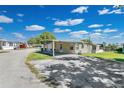 The manufactured home features a carport, exterior shed, and well-maintained landscaping at 1405 Westland Dr, Tavares, FL 32778