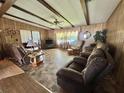 Relaxing living room with tile flooring, comfy seating, and neutral toned walls at 141 Hibiscus Way, Leesburg, FL 34748