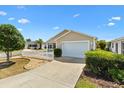 Attractive single-story home with a well-maintained lawn, and a one car garage with driveway at 2224 Mangrove Ln, The Villages, FL 32162