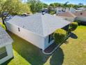 A back aerial view of a single-story home with a clean roof and well-maintained yard at 2250 Peak Pl, The Villages, FL 32162