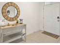 Bright foyer featuring a stylish wood mirror and decorative console table at 2897 Sunridge Loop, St Cloud, FL 34771