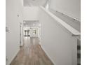 Bright foyer featuring wood-look tile flooring, staircase, and open layout at 29447 Caspian St, Leesburg, FL 34748