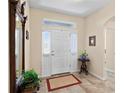 Bright foyer featuring a neutral color palette, tile flooring, and a decorative rug at 3666 Arlington Ridge Blvd, Leesburg, FL 34748