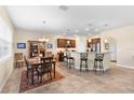 Spacious kitchen and dining area with modern appliances and a breakfast bar at 3666 Arlington Ridge Blvd, Leesburg, FL 34748