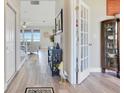 Welcoming entryway with wood floors, stylish decor, and an open view to a bright living space at 403 Blue Cypress Dr, Groveland, FL 34736