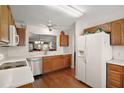 Bright kitchen with white countertops, stainless steel appliances, and wood cabinets at 604 Juanita Ct, The Villages, FL 32159