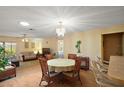 Bright and open living area with a chandelier, ceiling fan, and sliding glass doors to the patio at 7650 Se 174Th Gaillard Pl, The Villages, FL 32162