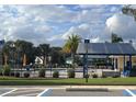 Community pool with shade and seating area, surrounded by lush landscaping, creating a perfect spot for relaxation at 1018 Fiesta Key Cir, Lady Lake, FL 32159