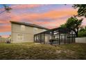 A lovely backyard featuring a screened-in pool, providing a perfect outdoor entertainment and relaxation space at 1454 Sterns Dr, Leesburg, FL 34748