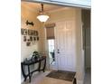 Charming entryway featuring a decorative table with elegant decor and a window at 2294 Caledonian St, Clermont, FL 34711