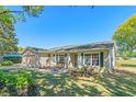 Inviting single-story house with a two-car garage, green shutters, and vibrant yard at 25642 Oak Aly, Leesburg, FL 34748