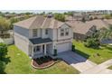 Aerial view of a well maintained two-story home on a sunny day at 2572 Limerick Cir, Grand Island, FL 32735