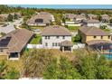 Birds-eye view of backyard and neighborhood featuring mature landscaping and privacy fence at 2572 Limerick Cir, Grand Island, FL 32735