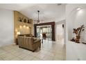 Comfortable living room with vaulted ceiling and access to sunroom at 25736 Whisper Oaks Rd, Leesburg, FL 34748