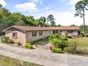 Beautiful brick home with decorative features, manicured landscaping, and a welcoming front entrance at 3452 N Washington St, Zellwood, FL 32798